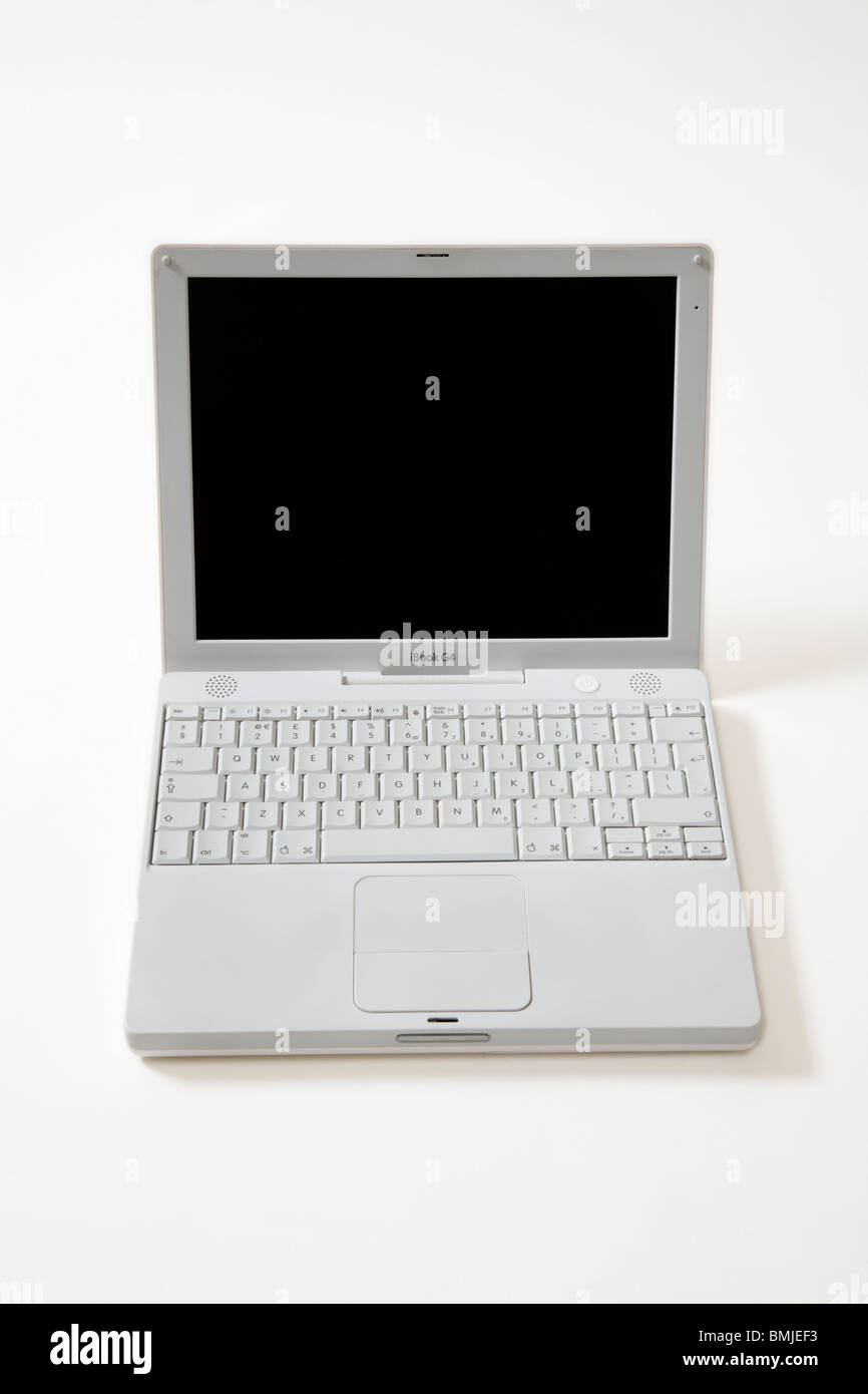 Apple iBook G4 laptop / lap top computer with scrolling TrackPad / trackpad / track pad, start / starting up screen & keyboard. Stock Photo