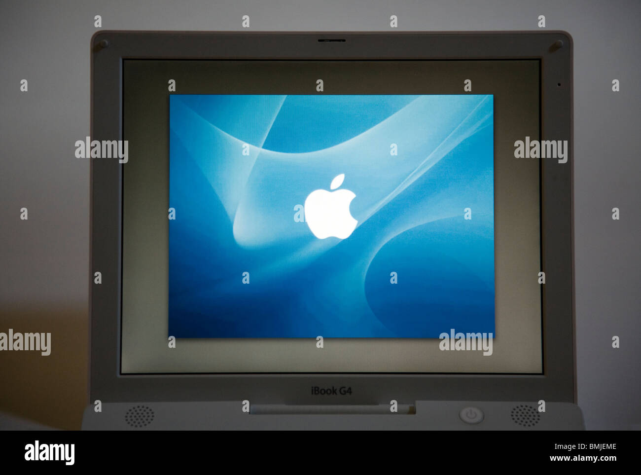 An Apple iBook G4 laptop / lap top computer start / starting up screen saver and keyboard. Stock Photo