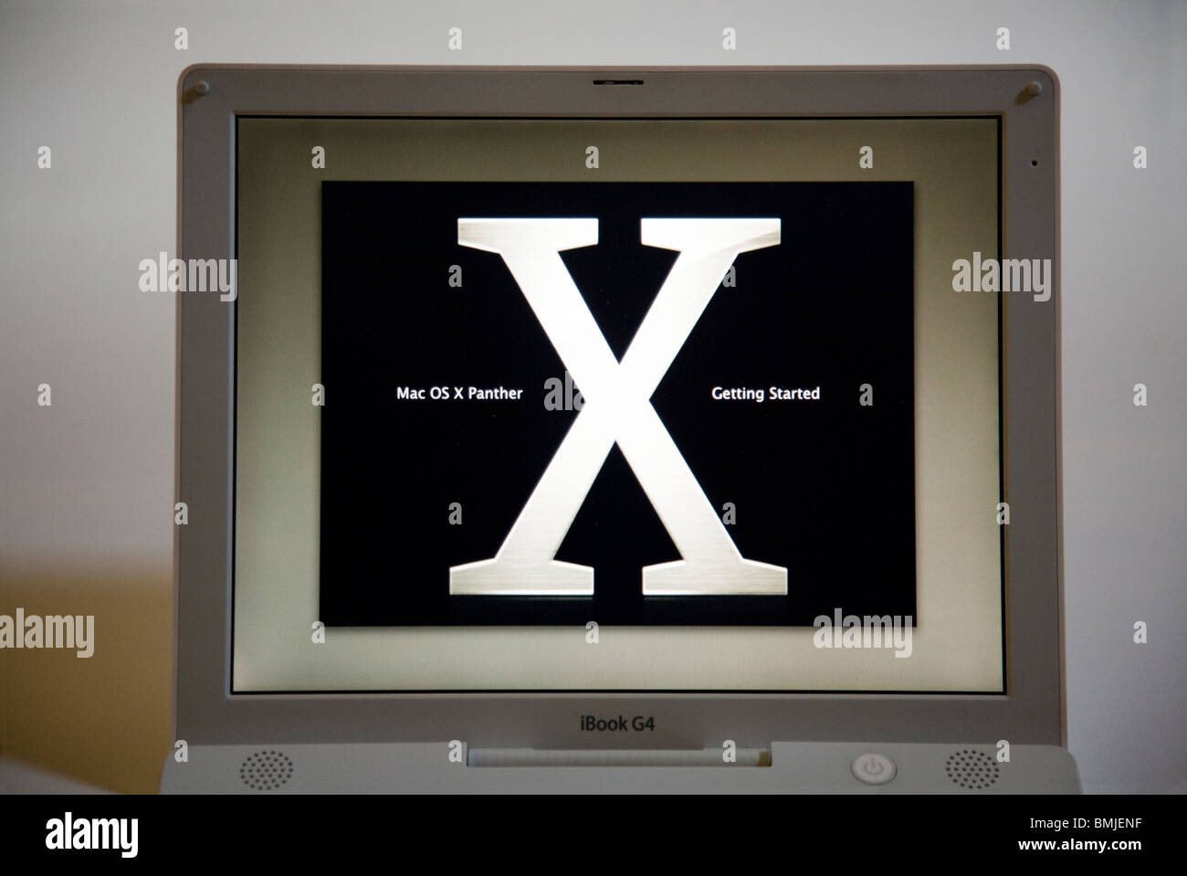 An Apple iBook G4 laptop / lap top computer start / starting up screen showing the OSX Panther logo. Stock Photo