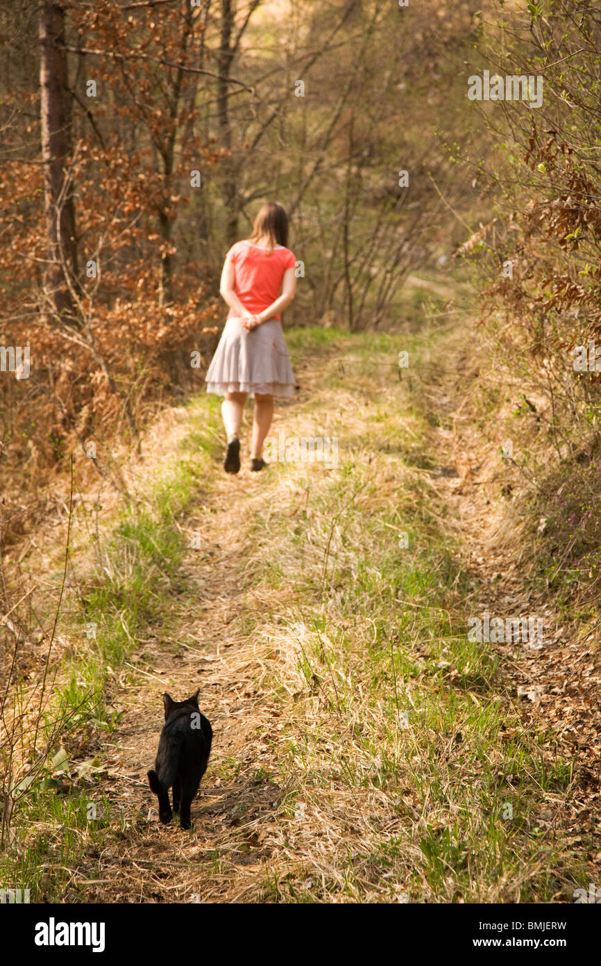 Black cat following girl in forest Stock Photo Alamy