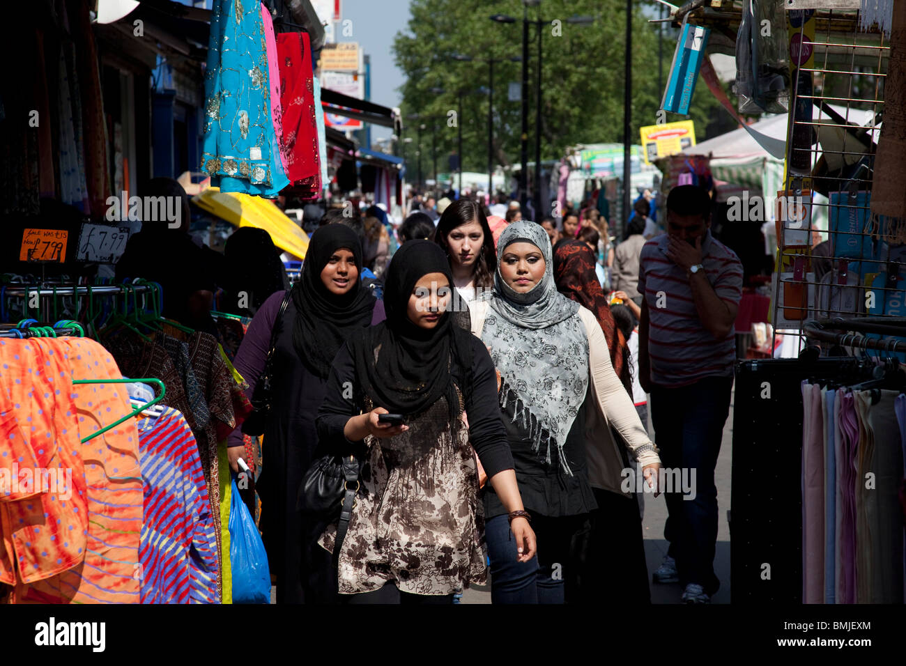 People from various ethnic backgrounds (mainly Muslim) around the market on Whitechapel High Street in East London. Stock Photo