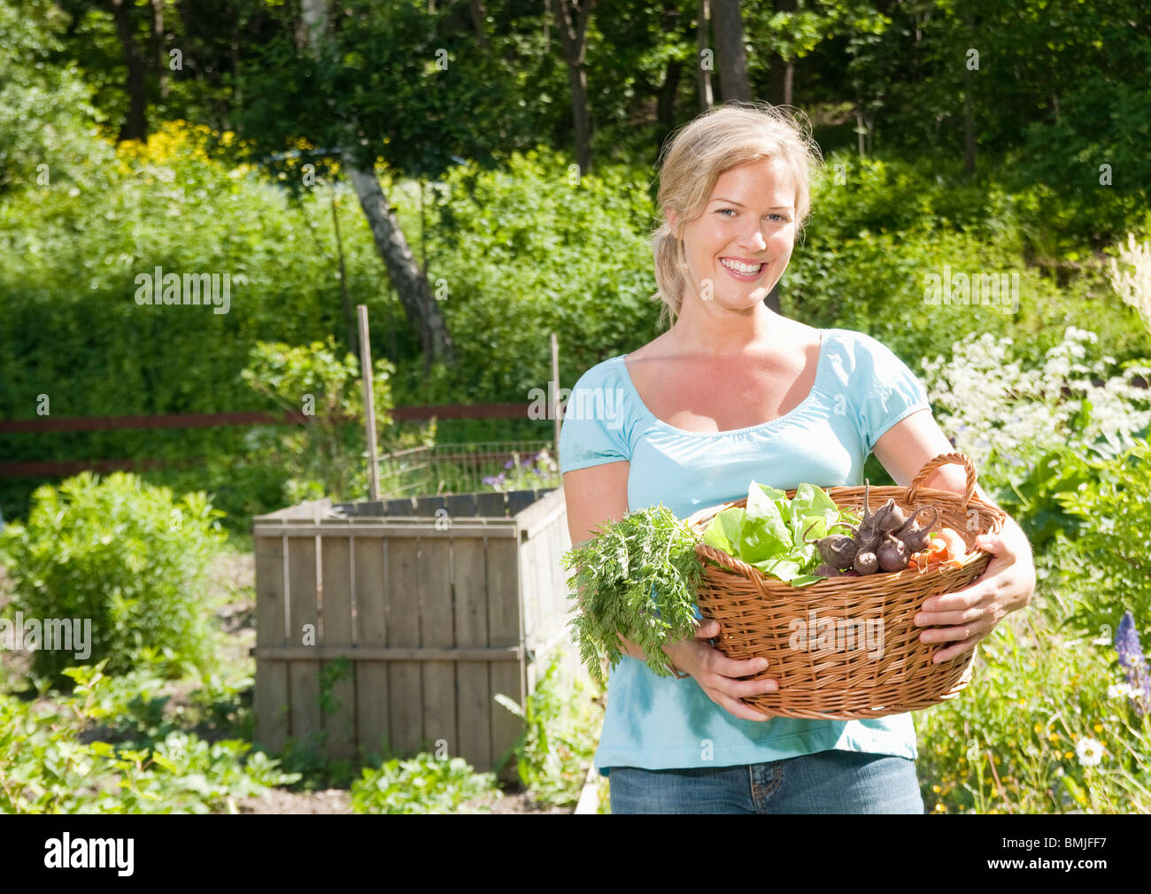 Woman carrying basket with vegetables Stock Photo Alamy