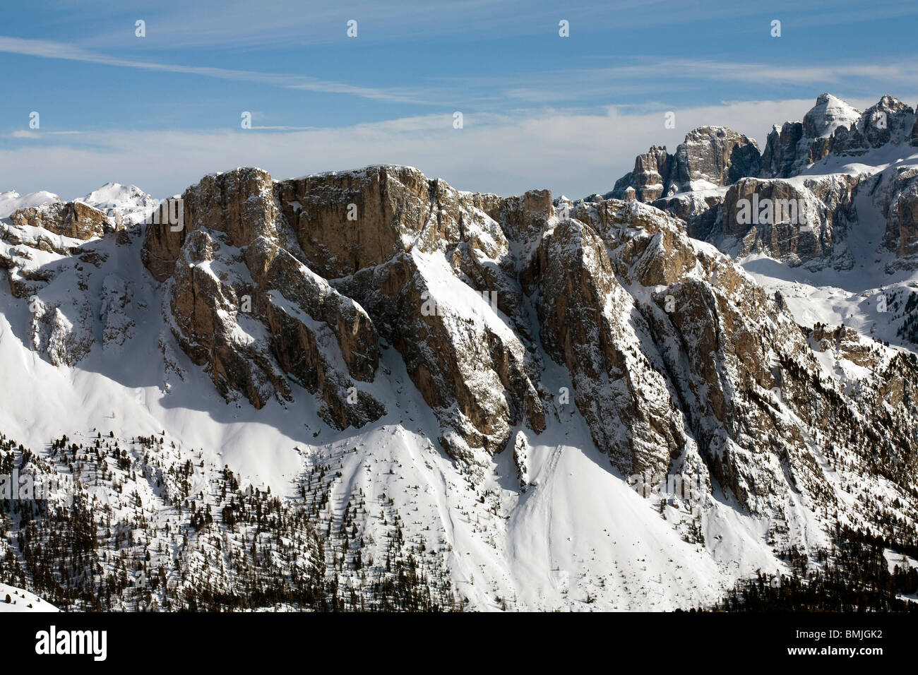 Dramatic cliff faces Pela De Vit Monte De Stevia above Selva Val Gardena winter Dolomites winter Stock Photo