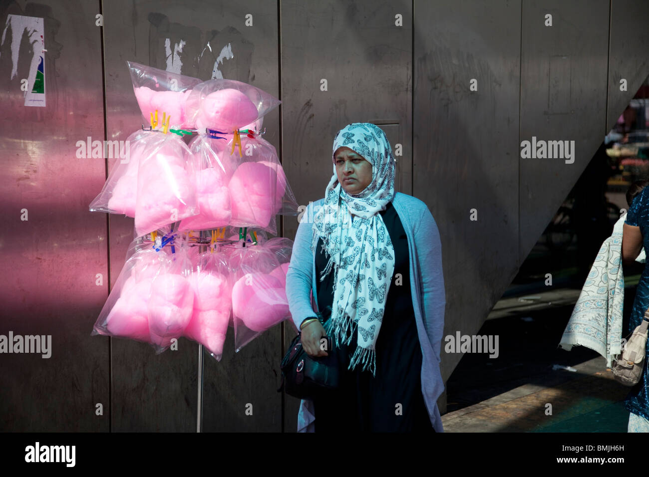 Muslim woman around the market on Whitechapel High Street in East London. Stock Photo