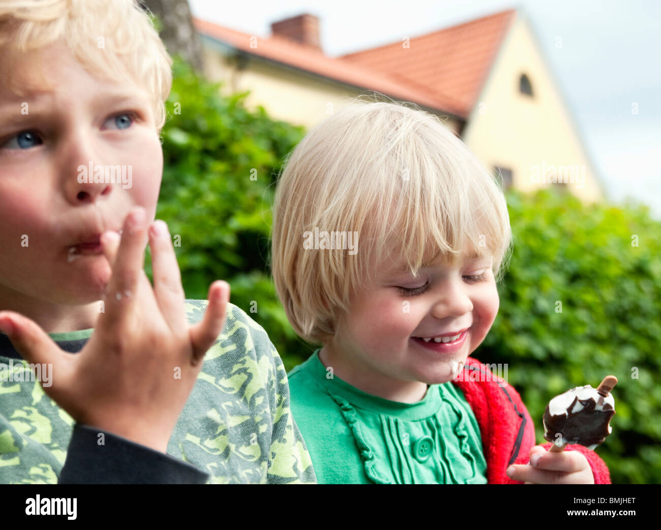 Two children eating ice cream Stock Photo Alamy