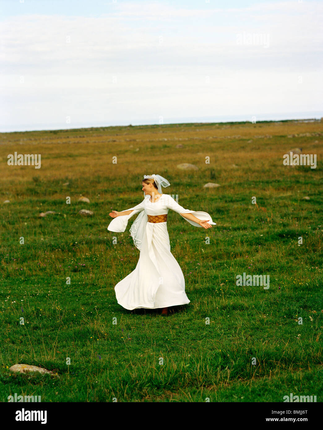 Scandinavia, Sweden, Oland, Bride dancing in field Stock Photo