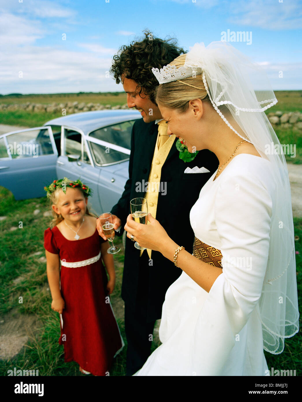 Scandinavia, Sweden, Oland, Bride and groom with flower girl, smiling Stock Photo
