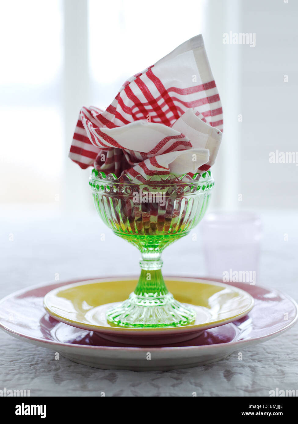 Scandinavia, Sweden, Stockholm, Napkin in glass with plates on table, close-up Stock Photo