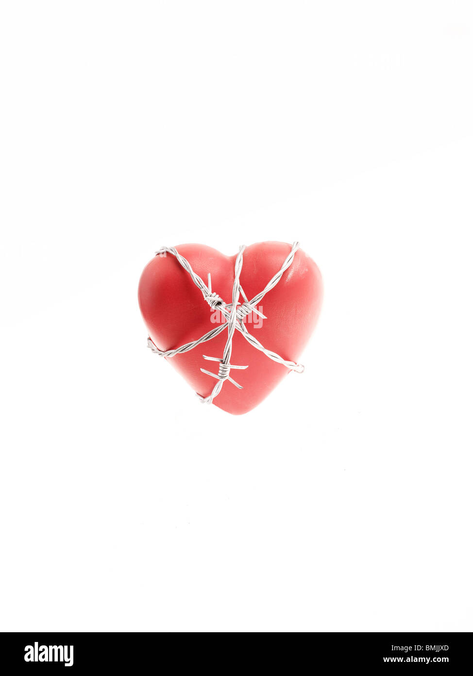 Barbed wire around a red heart. Stock Photo