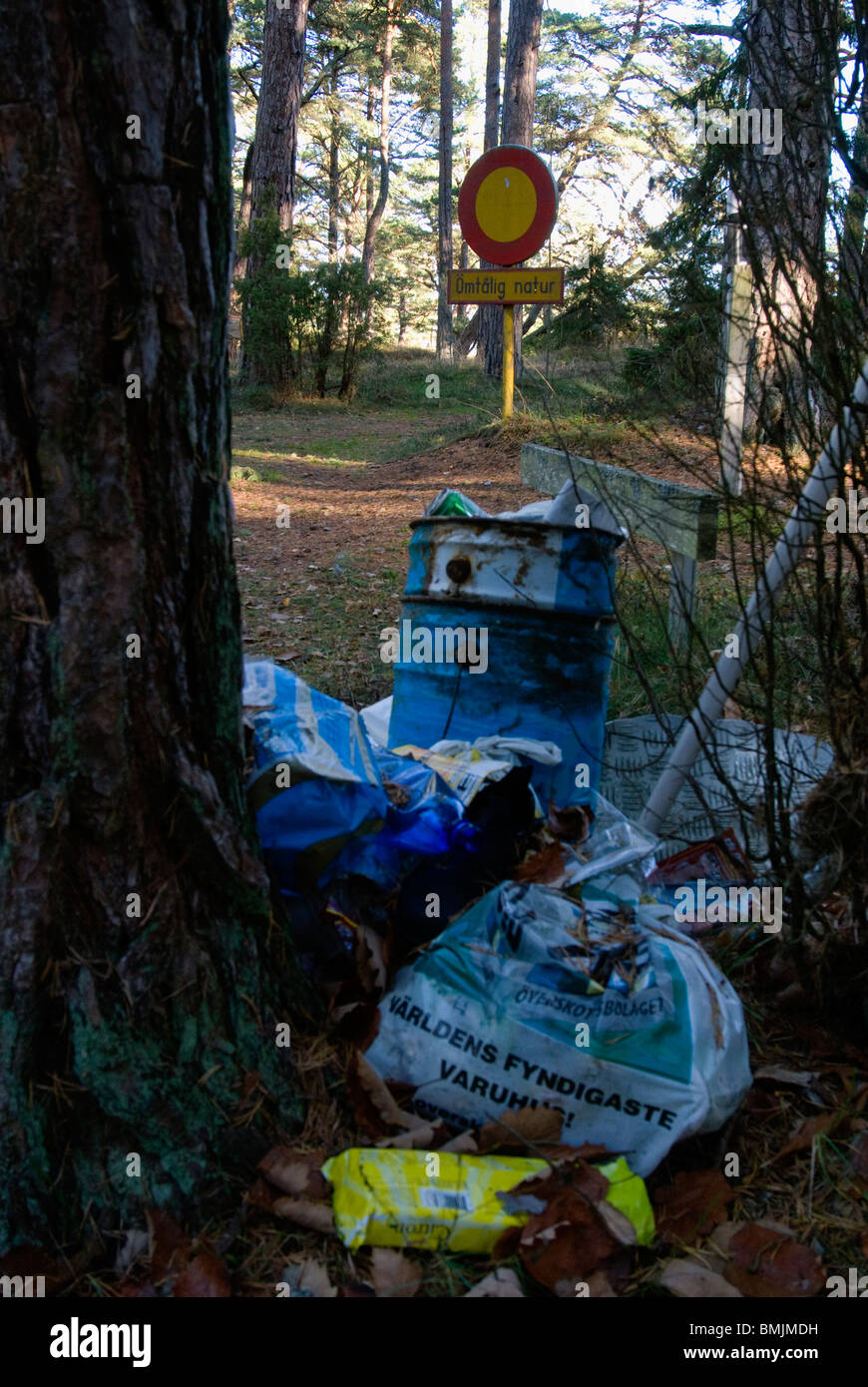 Scandinavia, Sweden, Oland, Rubbish and sign post in forest Stock Photo