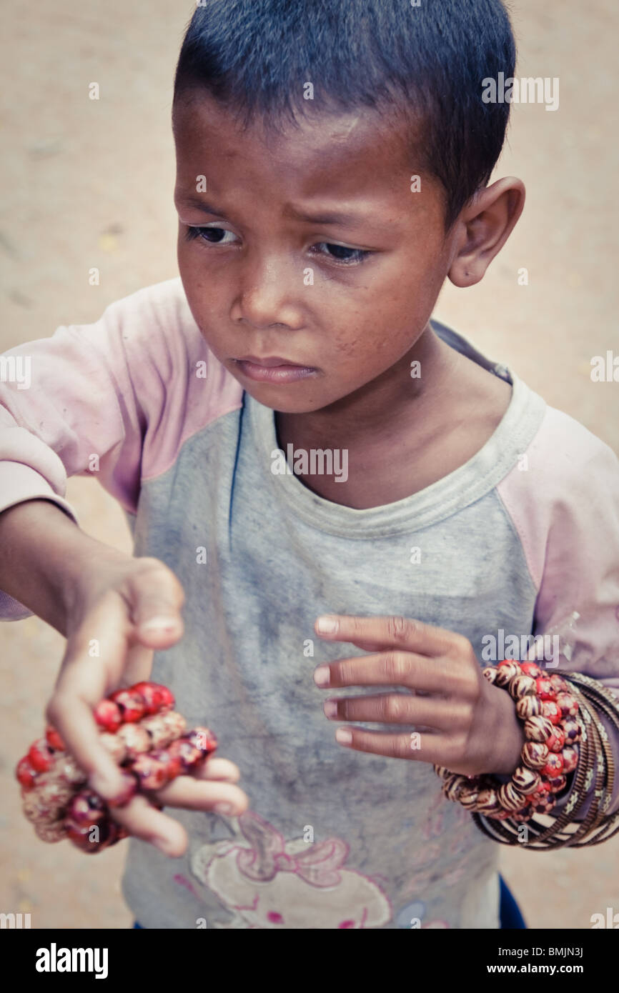 Cambodian child street vendor in angkor wat Stock Photo