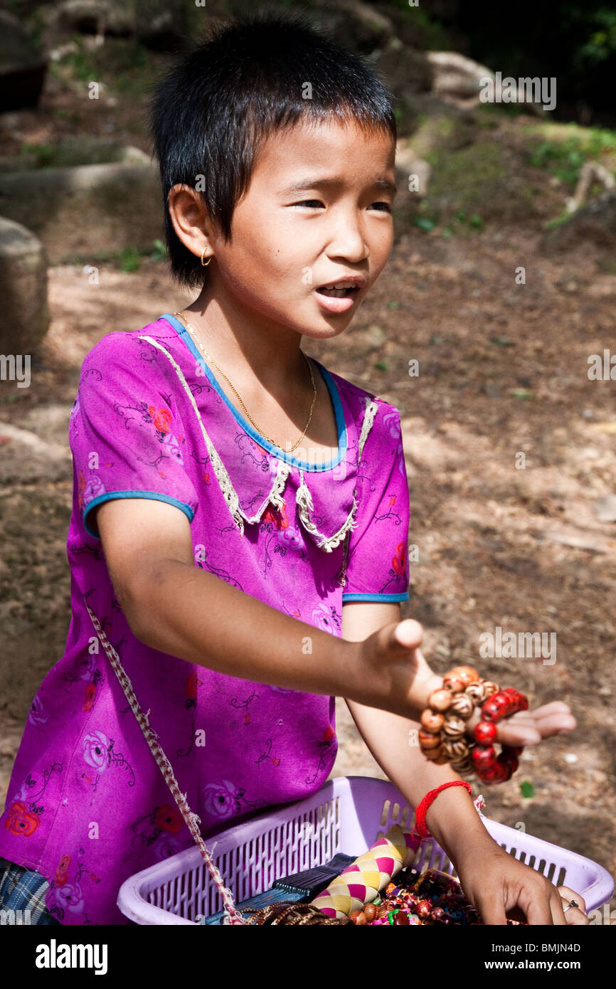 Child street vendor in Cambodia, Angkor Wat selling souvenirs Stock Photo