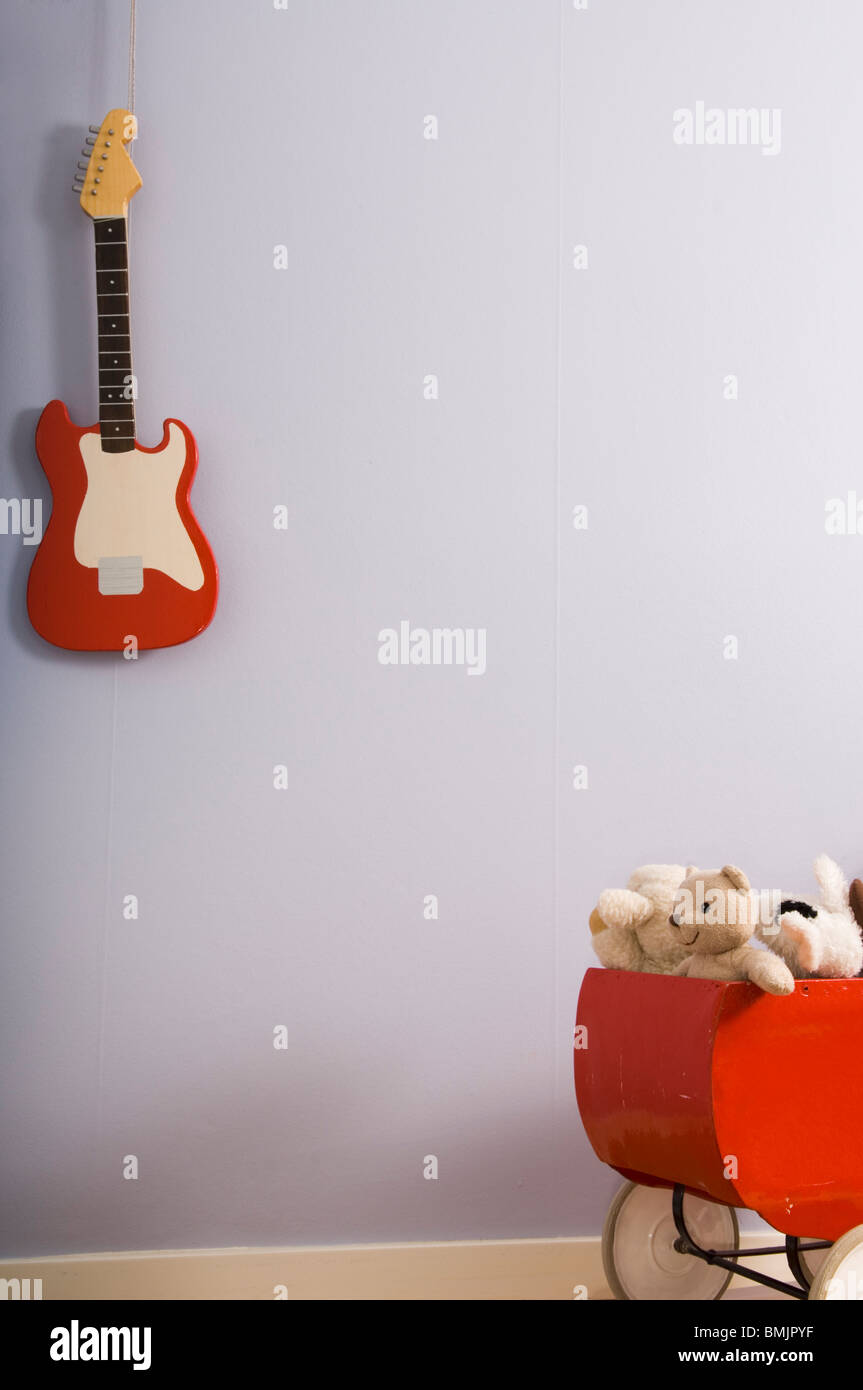A doll''s pram and a guitarr Stock Photo