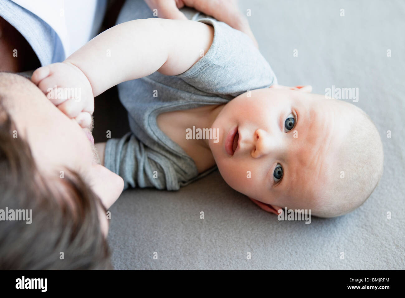 Baby boy with dad looking up to camera Stock Photo Alamy