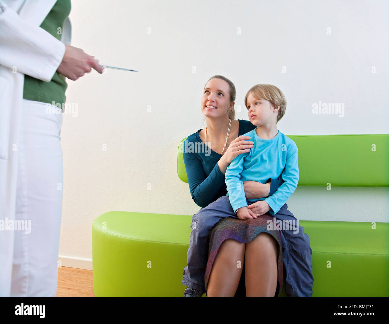 Doctor with patient in waiting area Stock Photo
