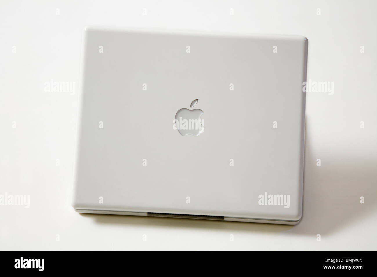An open Apple iBook G4 laptop / lap top computer showing the Apple logo. Stock Photo