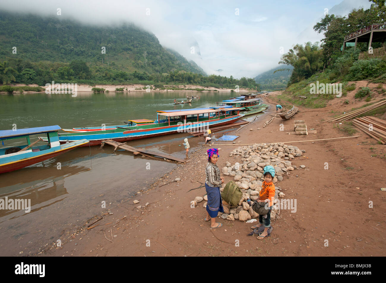 Lao villagers on the banks of the Nam Ou river at Muang Ngoi northern Laos Stock Photo