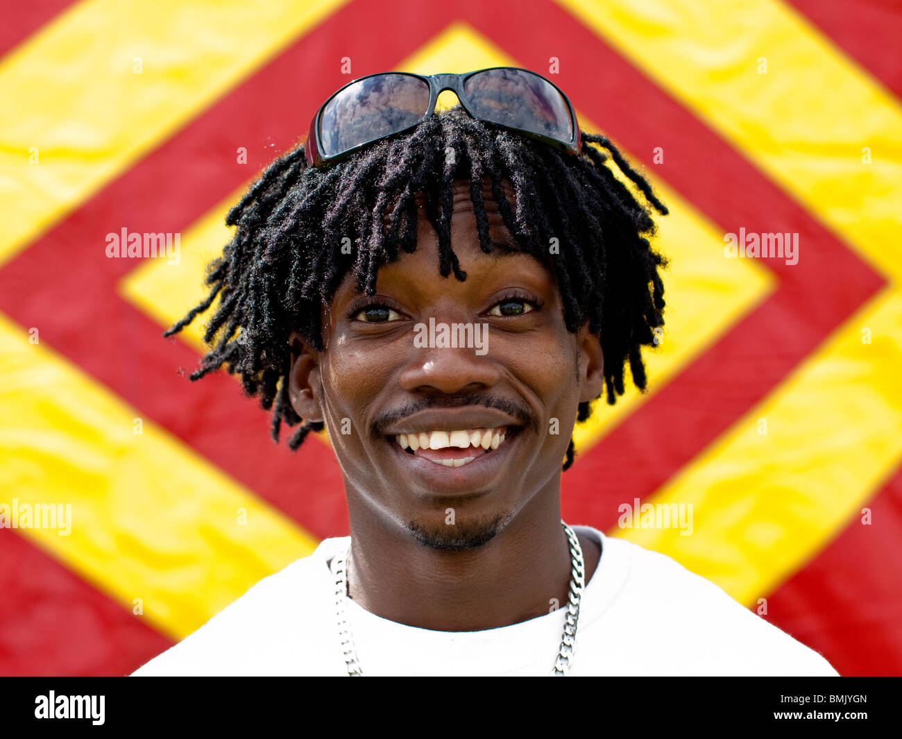 Black male Afro-Caribbean-look bright smile sunglasses dreadlocks Stock Photo