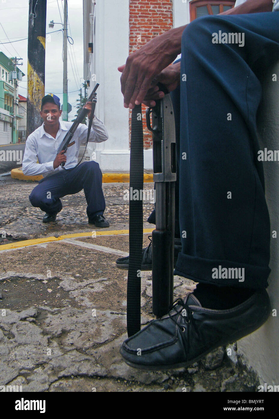 Private armed security guards outside a bank in Puerto Plata, Dominican Republic Stock Photo