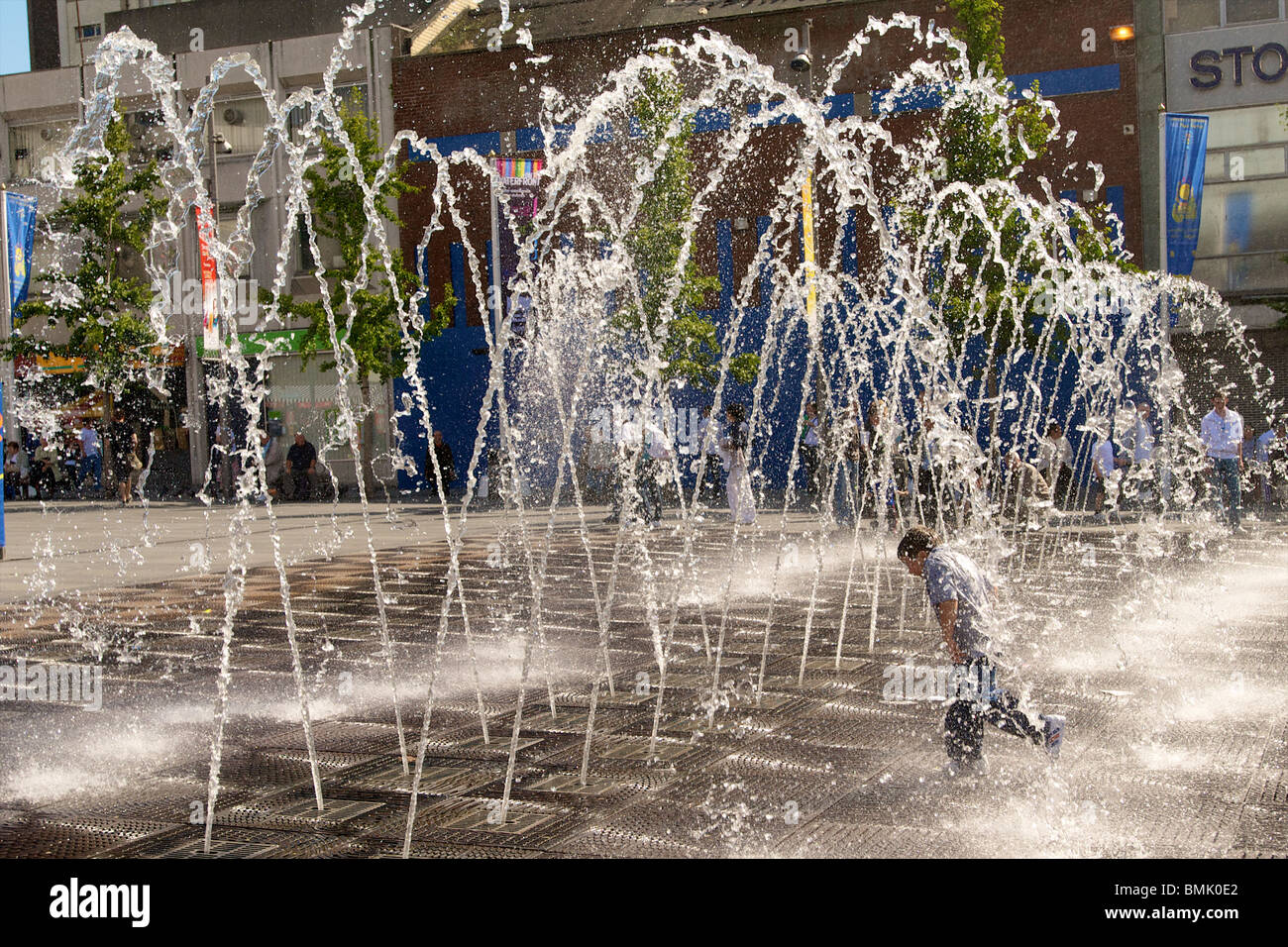 The fountain in Williamson Square in Liverpool with boy running through it. Stock Photo