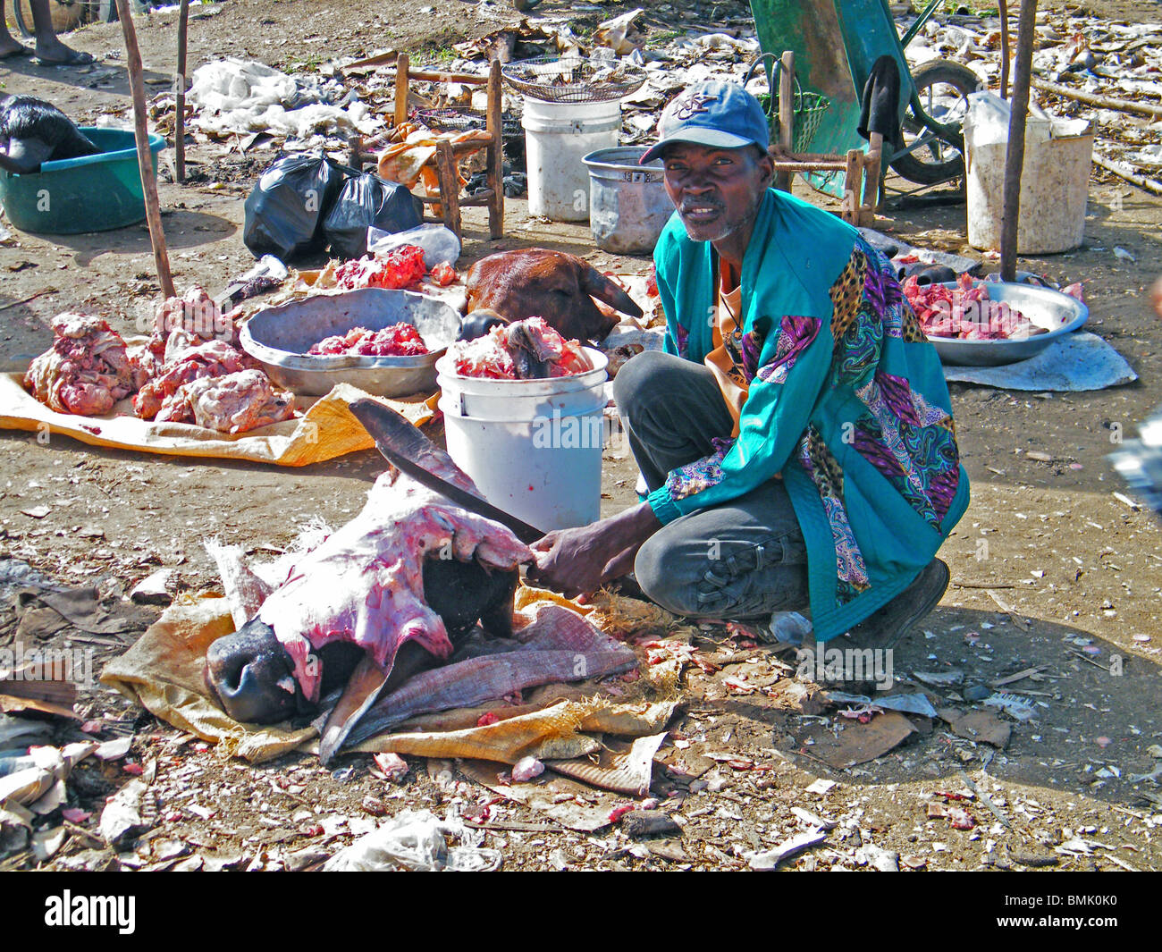 A man sells cows heads at a meat market in Ouanaminthe, Haiti Stock