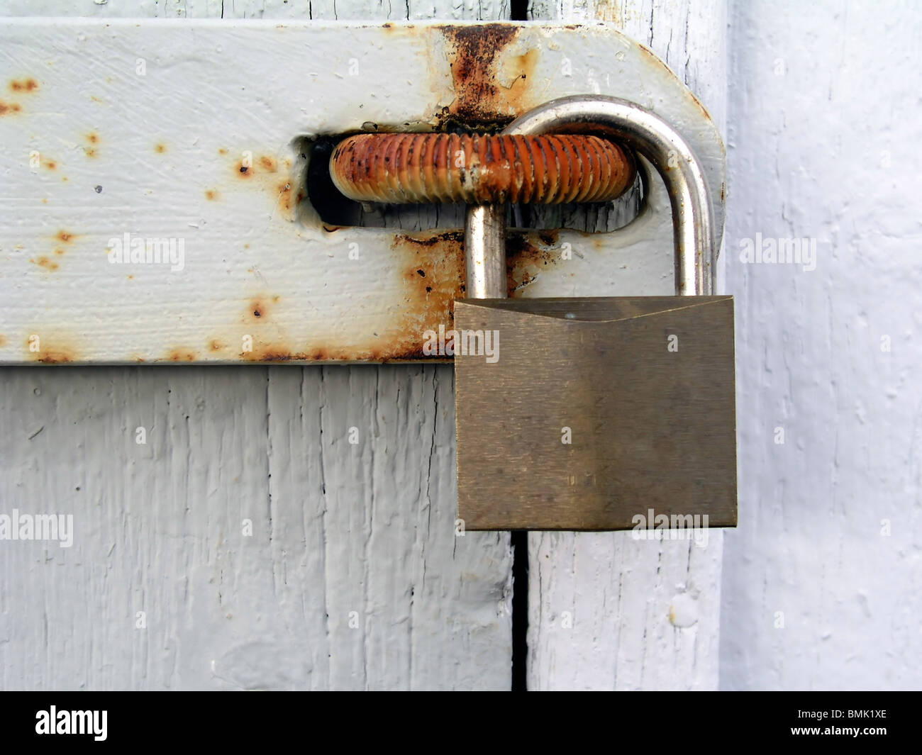 Old rusty padlock on white wood door closeup Stock Photo - Alamy