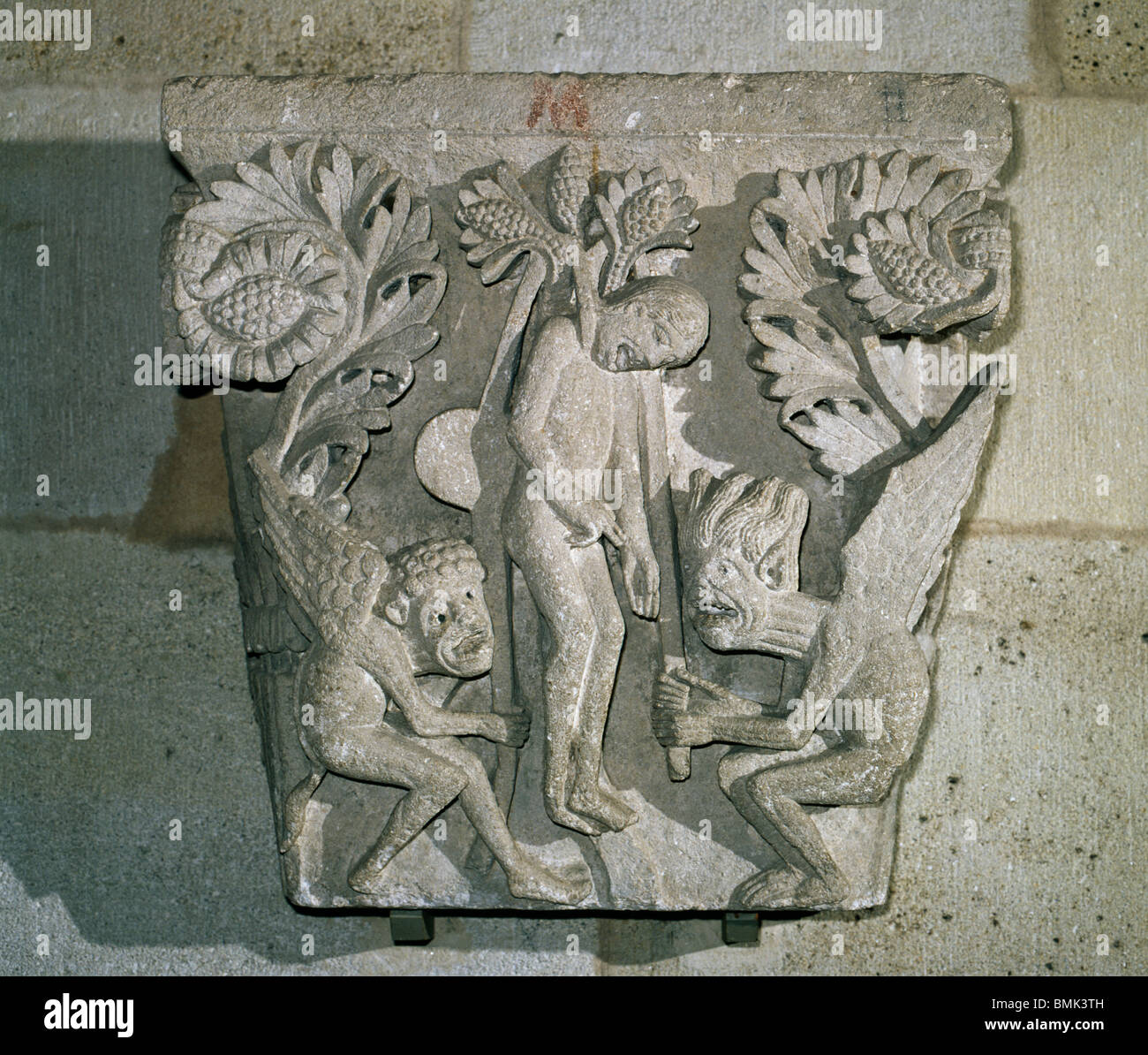 Autun Cathedral, France. Romanesque capital showing suicide of Judas,  with demons pulling on ropes as Judas hangs. Stock Photo