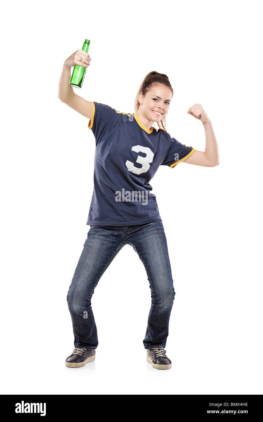 Female sport fan celebrating with a beer bottle in her hand Stock Photo