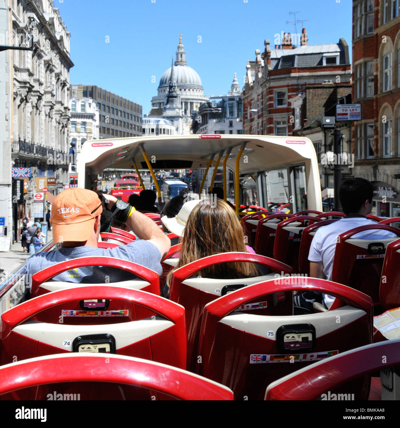 Tourists on open top tour bus approaching St Pauls Cathedral Stock Photo