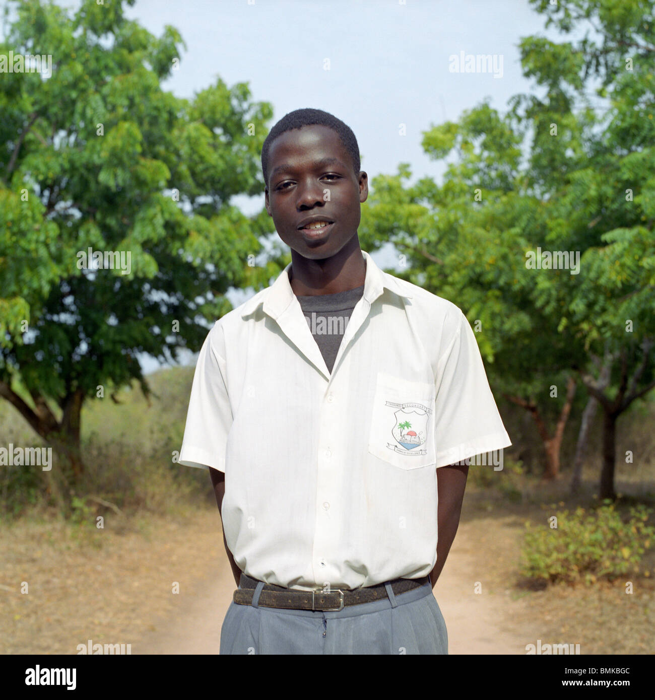 Young african boy in Kenya wearing a school uniform standing outside in