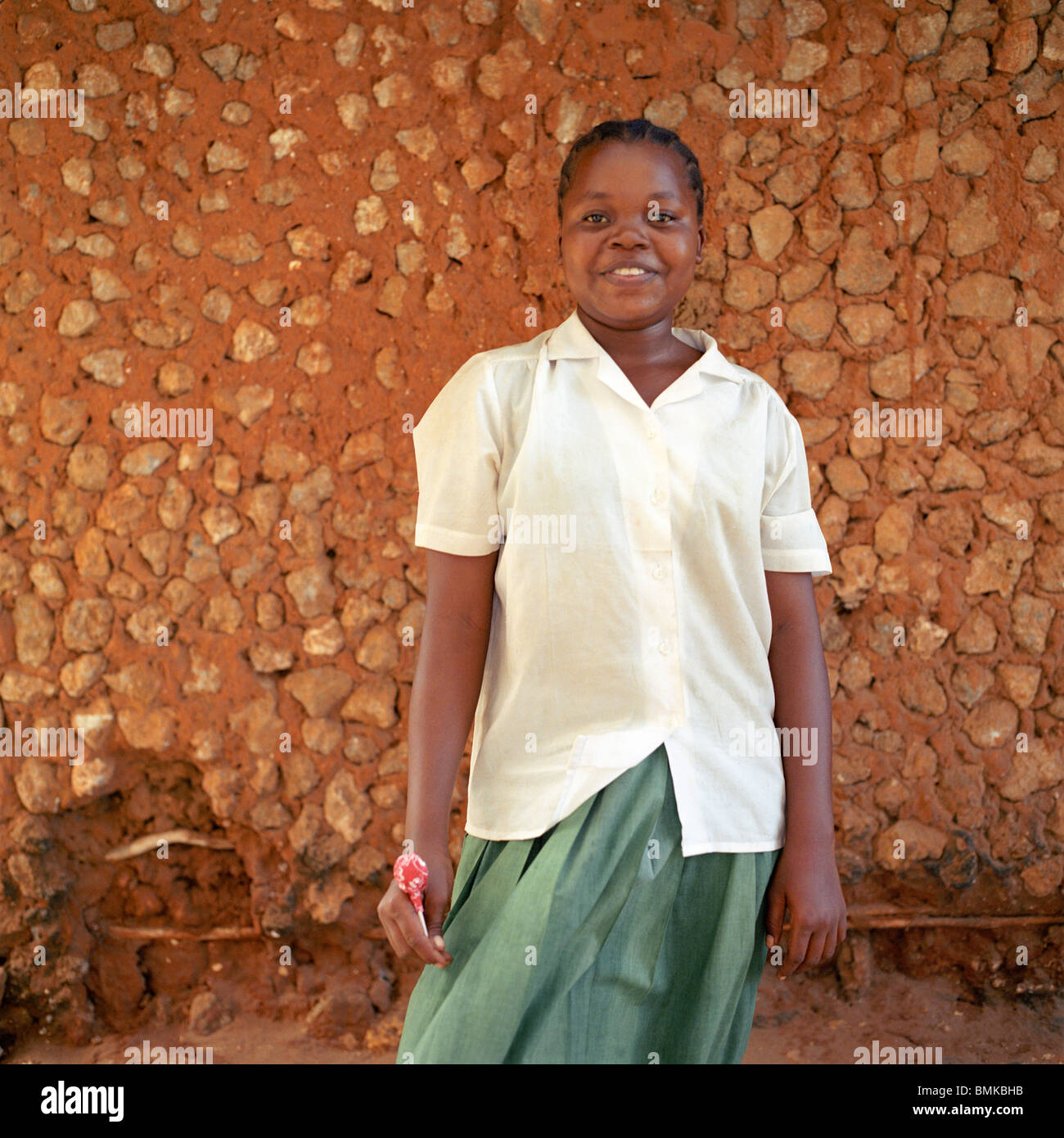 african girl in Kenya wearing a school uniform outside in front of a