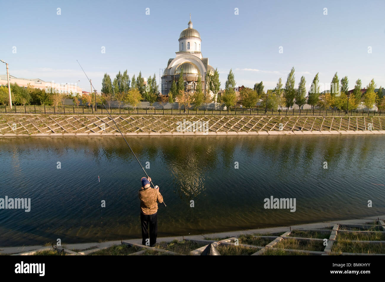 Fisher is fishing before a orthodox church, Astana, Kazakhstan Stock ...
