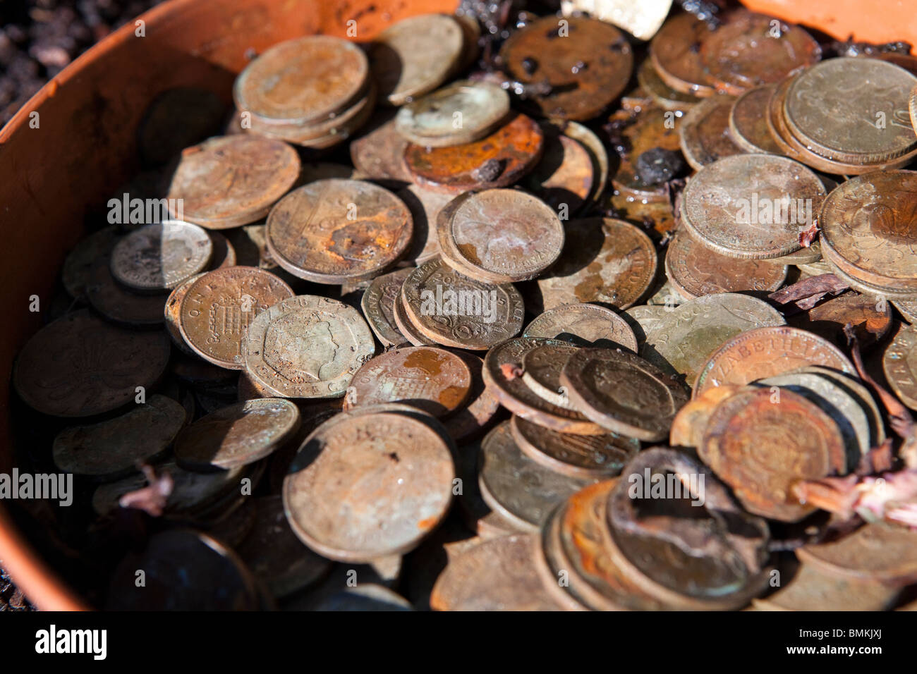 A pot of dirty and rusty English coins, mostly two and one pence pieces Stock Photo