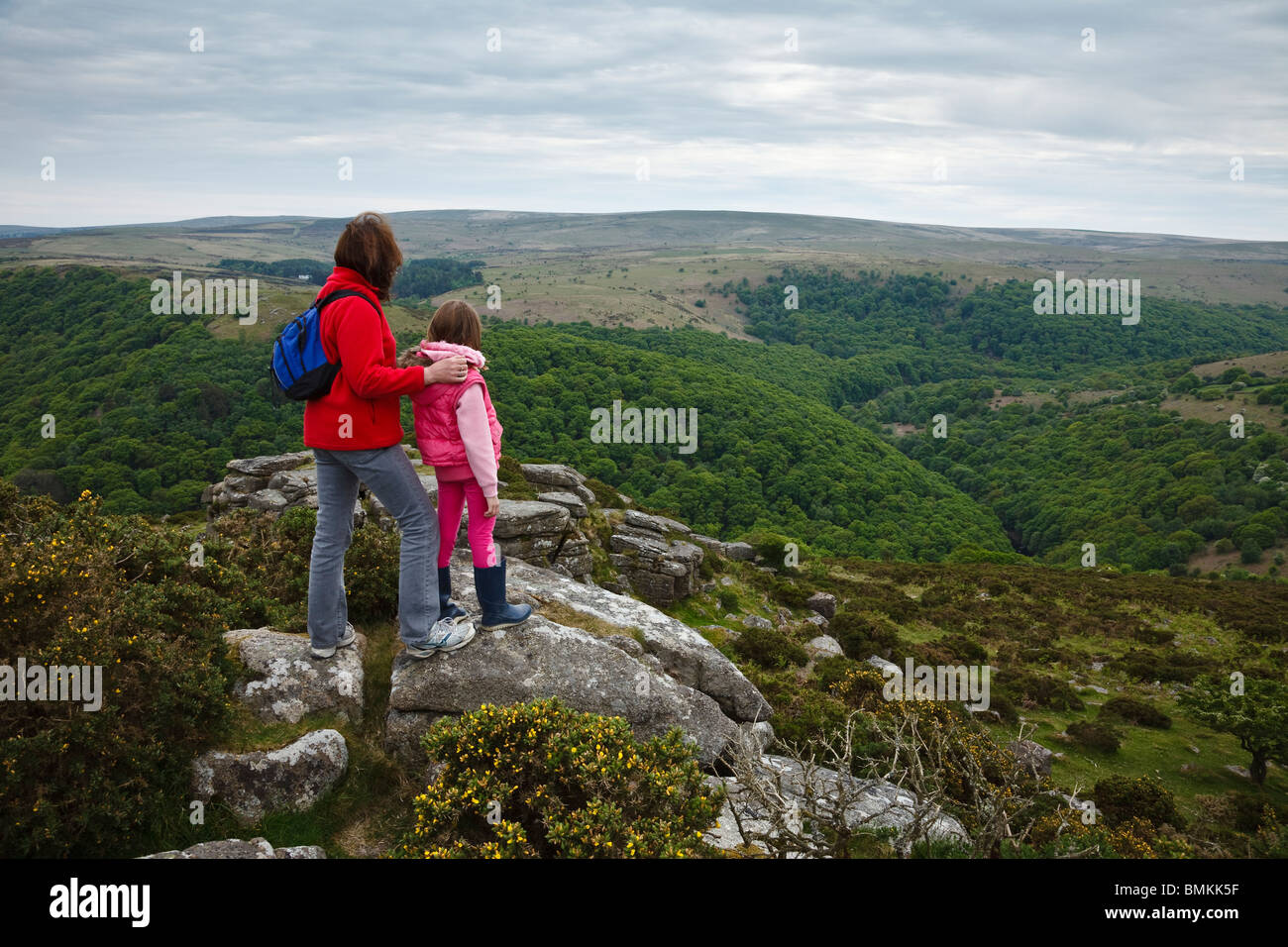 Mother and daughter admiring the view over the Dart Valley from Mel Tor, Dartmoor, Devon, England Stock Photo