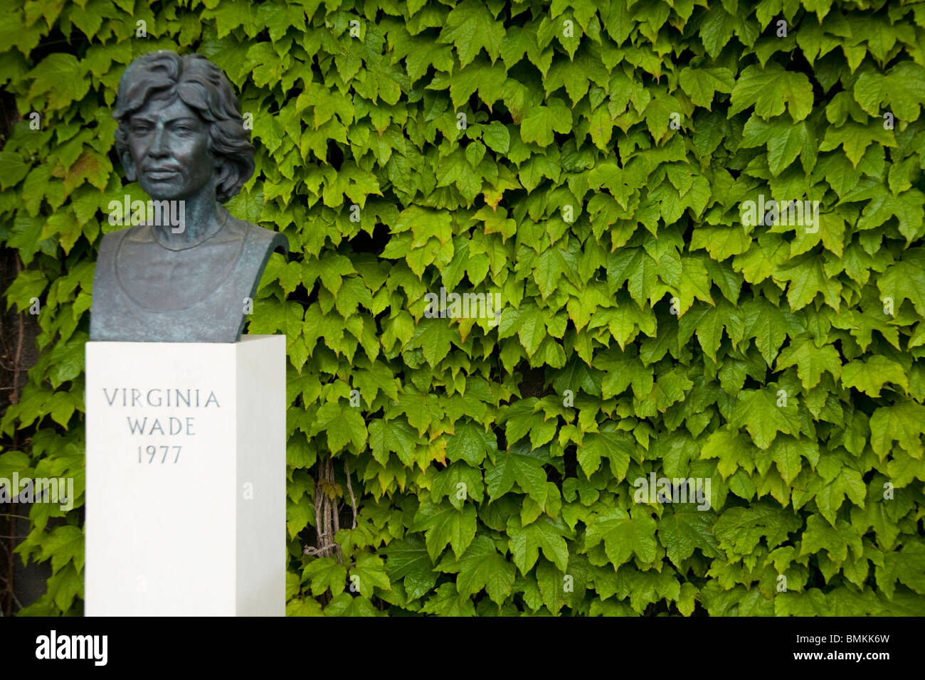 Statue of former British womens' / ladies' champion Virginia Wade, & creeper. Wimbledon tennis championship ground. London. UK Stock Photo