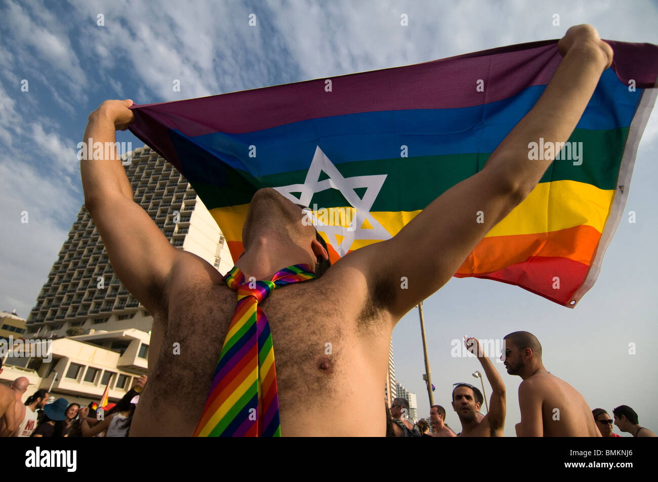 An Israeli man wave proudly the rainbow flag symbol of LGBTQ Pride bearing the Jewish Star of David at the annual LGBT Tel Aviv pride parade also called 'Love Parade' as part of the international observance of Gay Pride Month. Israel Stock Photo