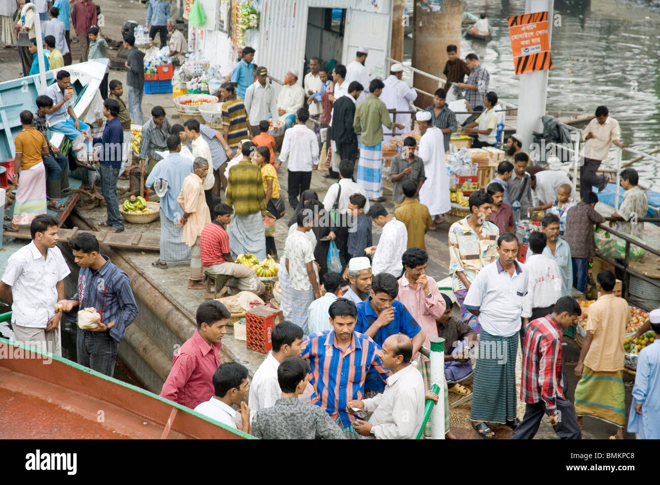 People get down from boat ; Sadarghat Boat terminal ; Dhaka ; Bangladesh Stock Photo