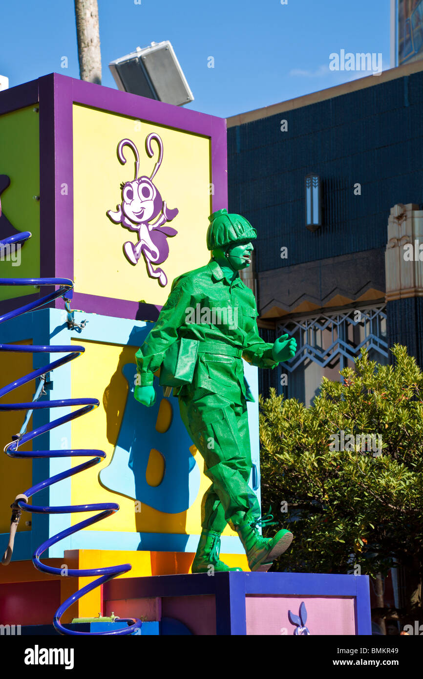 Green Army Man dancing on stack of toy blocks in the Block Party Bash parade at Disney's Hollywood Studios Stock Photo