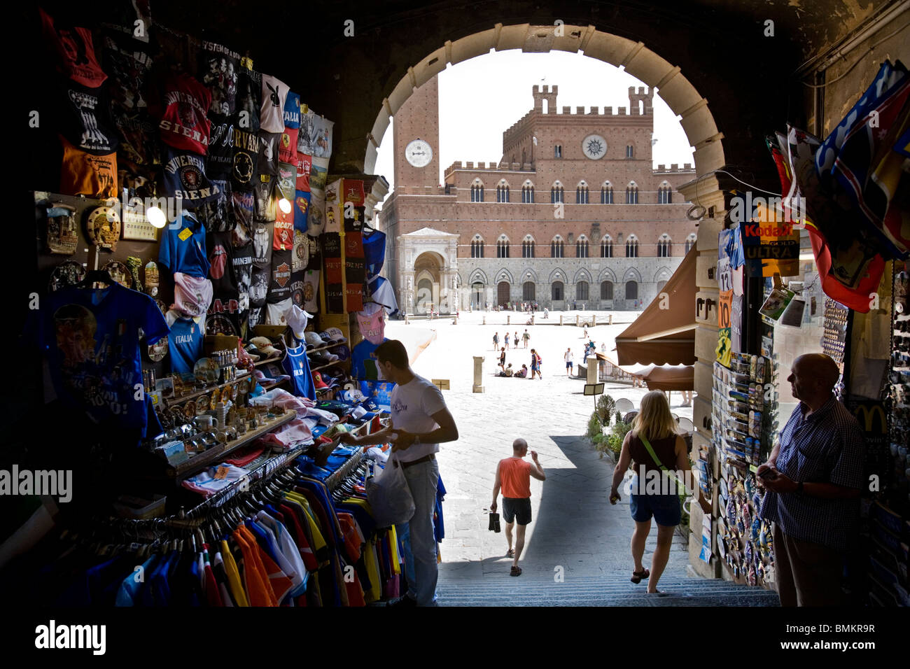 Merchandising sellers in the access arch in the Piazza del Campo Il Palio square, Sienna, Italy Stock Photo