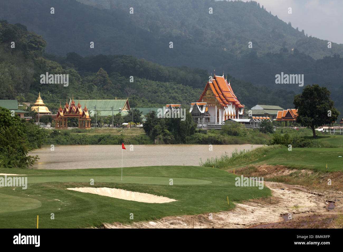 A Thai temple with golf course in foreground Stock Photo