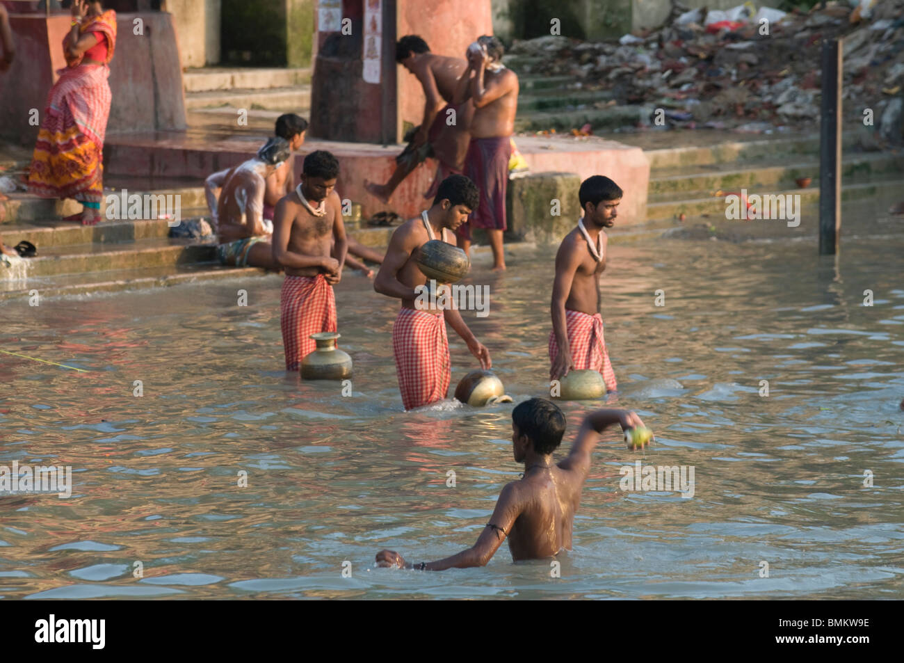 People bathing in shallow water of the Hoogly river, Calcutta, India Stock Photo