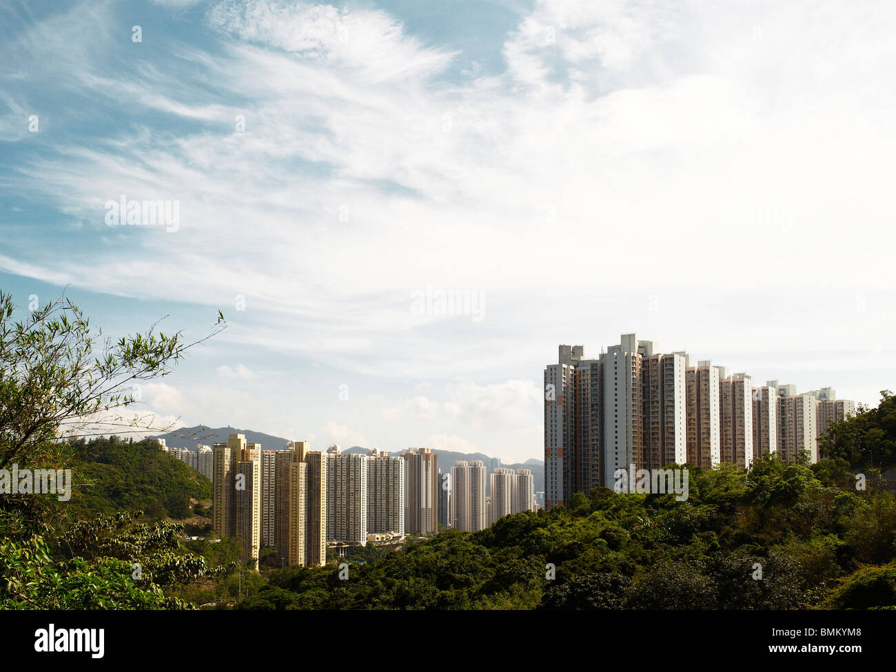 Towers of residential apartment building blocks stand tall on the mountain back, accommodating the growing population. Stock Photo