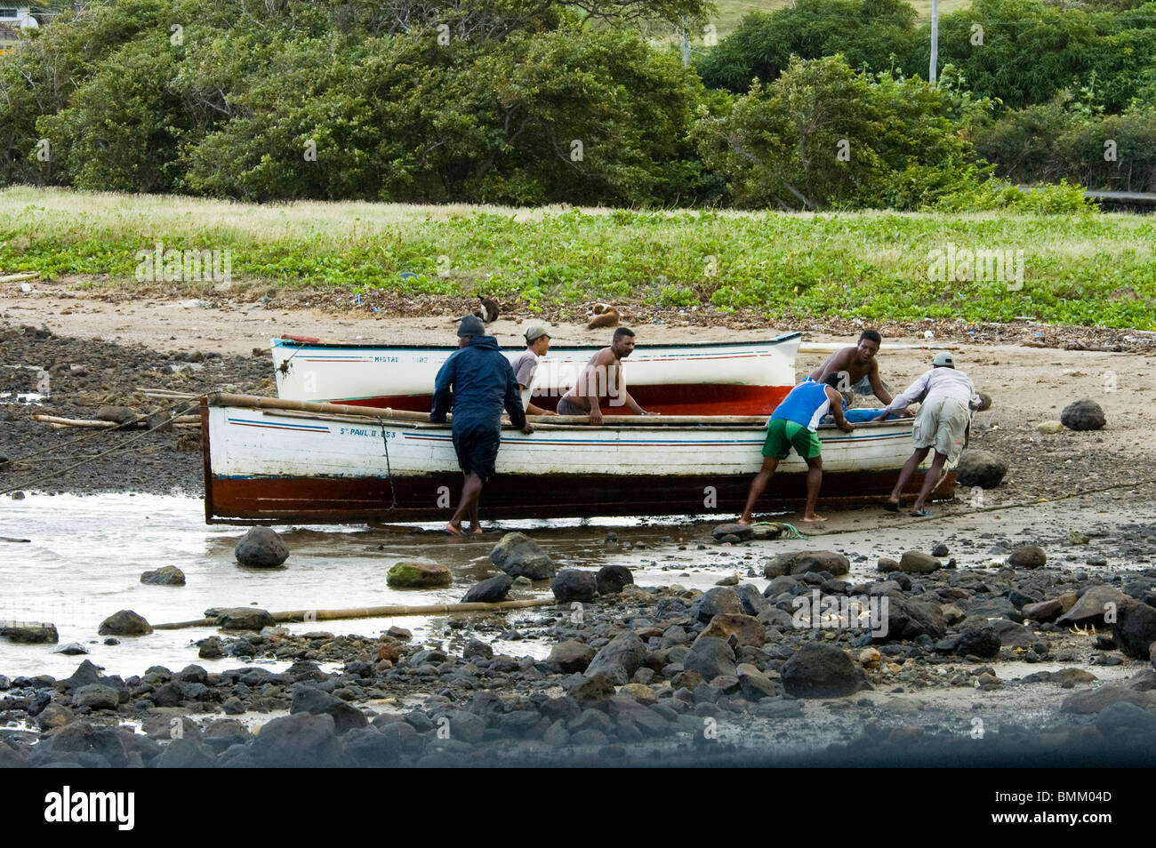 Mauritius, Rodrigues Island, Fishermen hauling a boat Stock Photo
