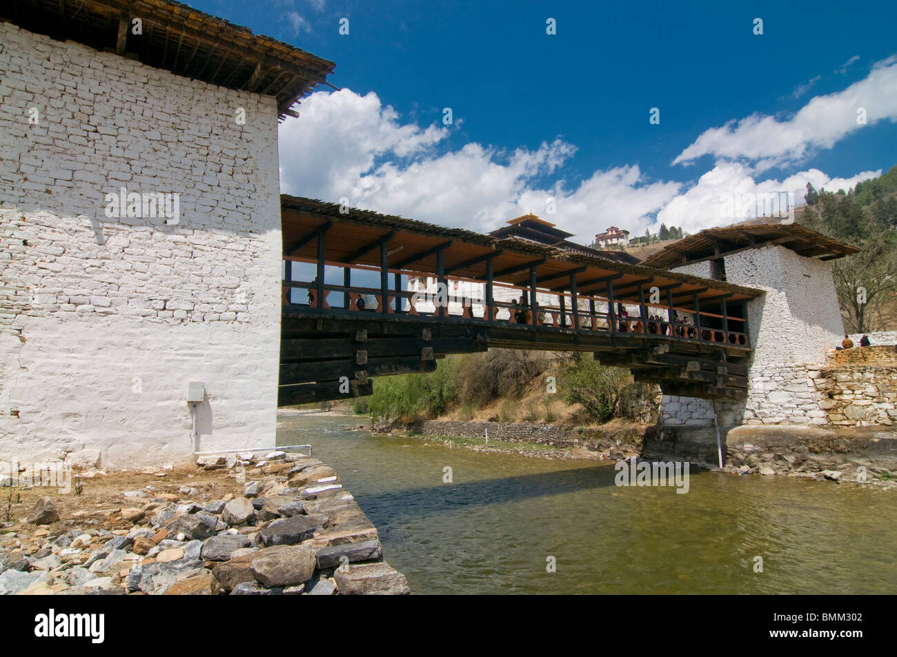 River Paro Chhu with wooden bridge and the Tsong of Paro,Bhutan,Asia Stock Photo