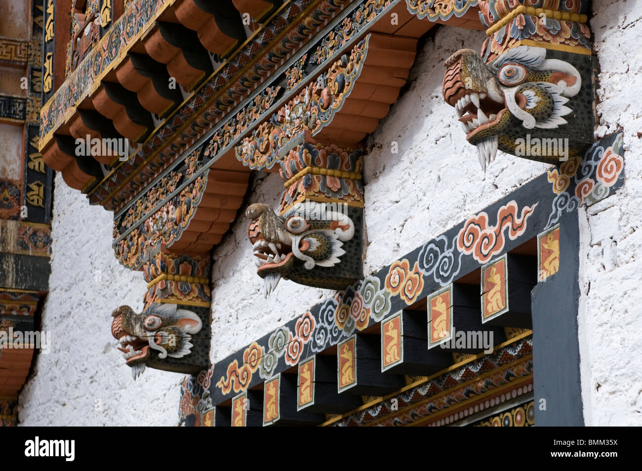 Typical wooden fassades with dragons in the palace of Punakha, Tsong. Bhutan. Asia. Stock Photo