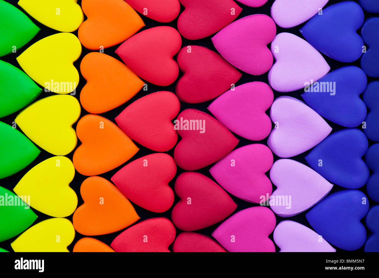 Multicoloured heart shape pattern against black background Stock Photo