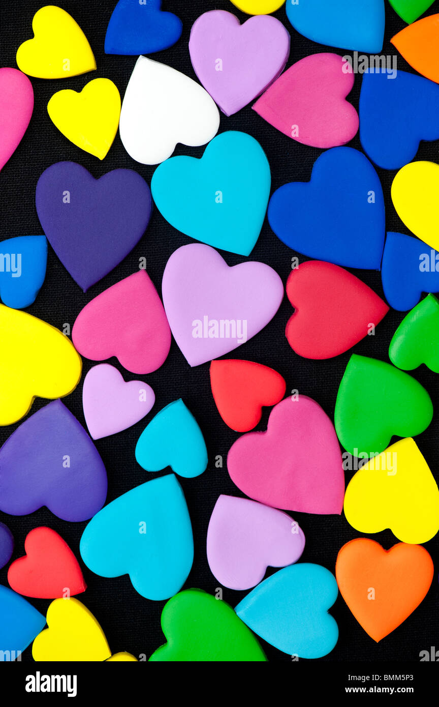 Multicoloured heart shape pattern against black background Stock Photo