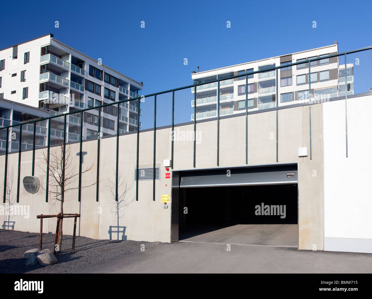 Underground parking hall door opening to a parking space underneath a Finnish block of flats , Finland Stock Photo