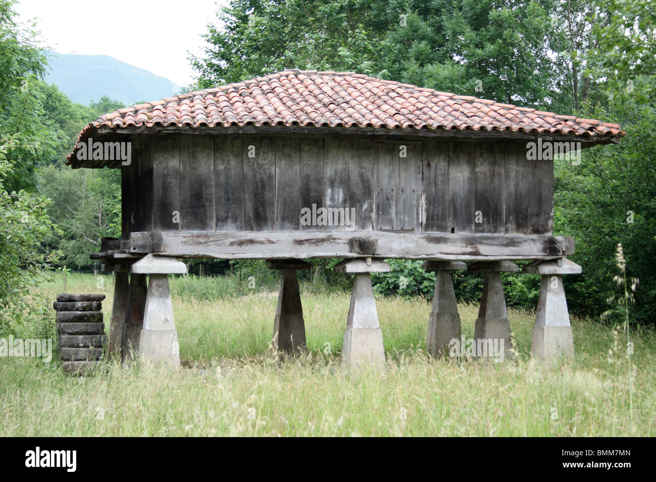 traditional wooden grain store on stone stilts, near