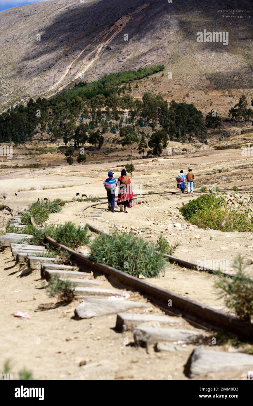 People walking along the disused railway line from Tarabuco near sucre in Bolivia Stock Photo